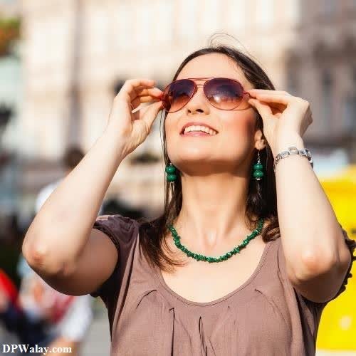 cool whatsapp dp - a woman wearing sunglasses and looking up