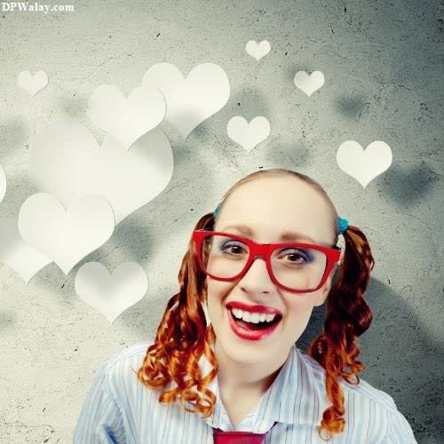 a girl with red hair and glasses is smiling