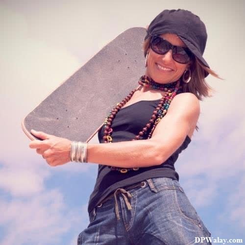 a woman holding a skateboard in her hands