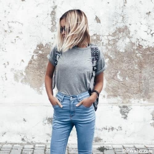 a woman in jeans and a gray shirt photo whatsapp dp 