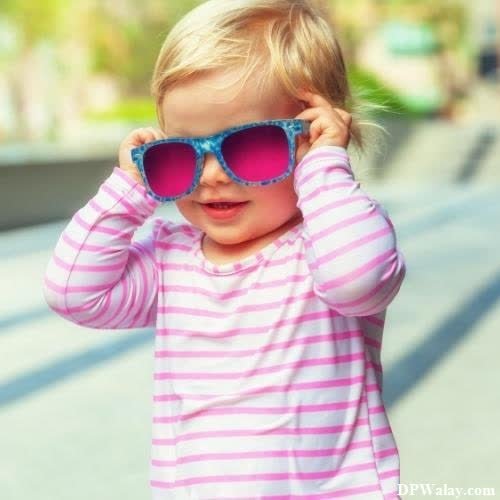 a little girl wearing sunglasses and looking at the camera photo whatsapp dp 