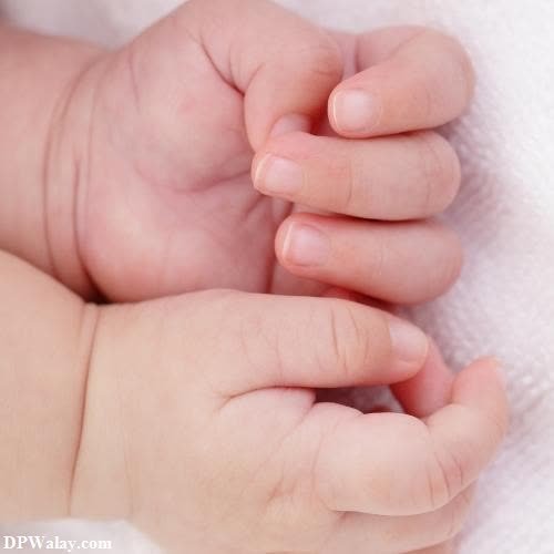cute whatsapp dp - a baby's hand on a white blanket