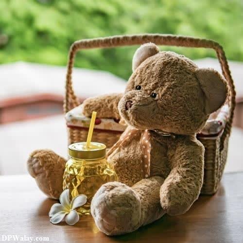a teddy bear sitting on a table with a basket of honey
