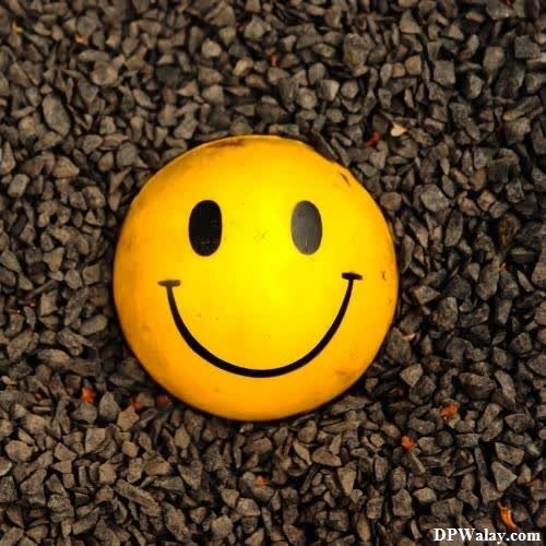 a smiley face ball sitting on the ground sweet whatsapp dp