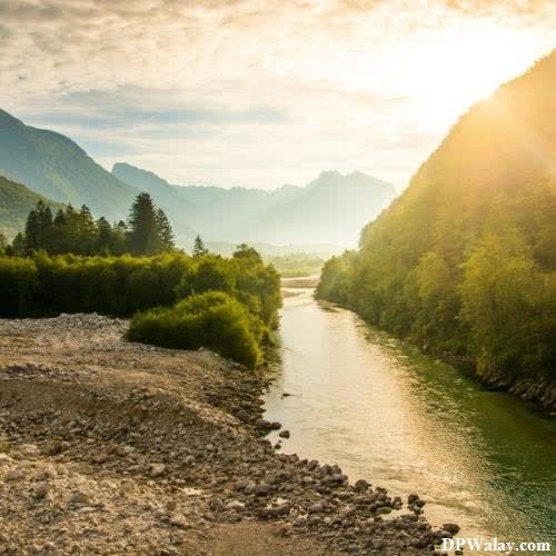 a river in the mountains with a sun shining over it wallpaper dp for whatsapp