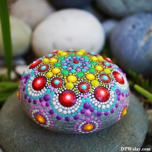 a rock with colorful stones and grass wallpaper dp for whatsapp 