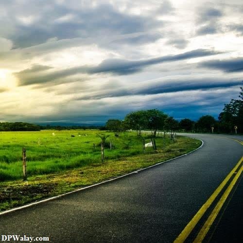a road with a field and a cloudy sky wallpaper hd for whatsapp dp