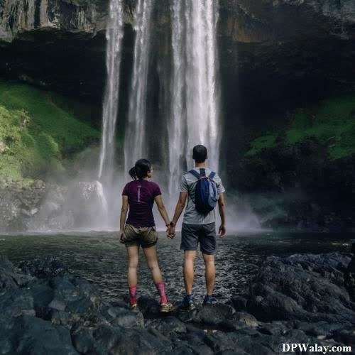 two people standing in front of a waterfall images by DPwalay