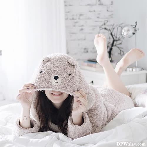 cute whatsapp dp - a woman laying on a bed with a teddy bear