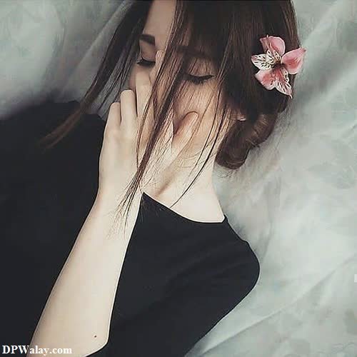 a woman laying on a bed with her hand on her face whatsapp dp cute 