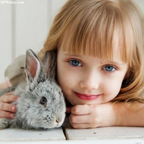 a little girl holding a rabbit in her hands whatsapp dp cuteness cute baby girl