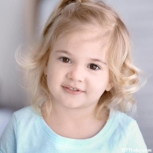 a little girl with blonde hair and blue eyes 