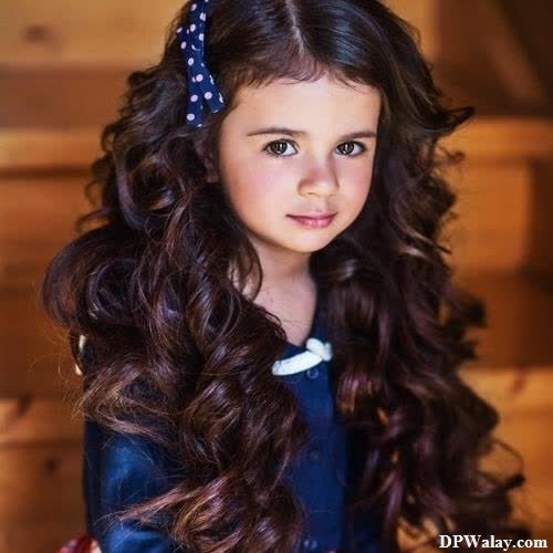a little girl with long brown hair and a blue dress whatsapp dp cuteness cute baby girl