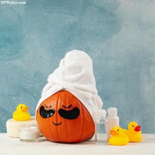 a pumpkin with a towel on it and a rubber duck in the background images by DPwalay