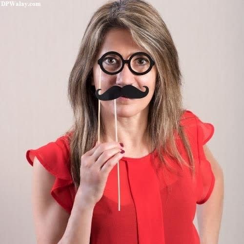 funny whatsapp dp - a woman in a red dress holding a fake mustache