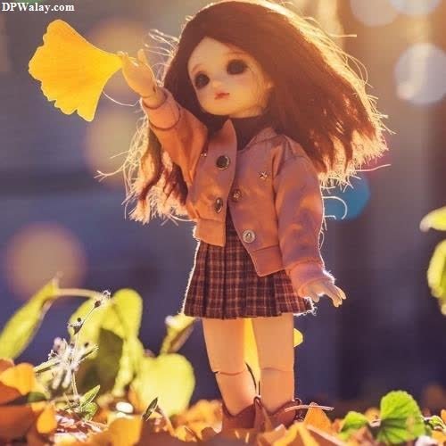 a doll is standing in the leaves barbie dp 