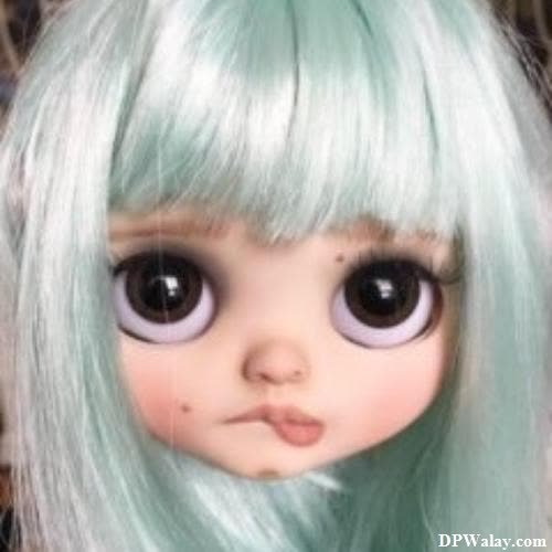 a doll with green hair and big eyes