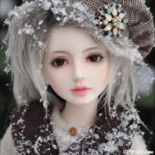 a doll with a hat and scarf on 