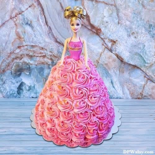 a barbie doll cake with pink and orange roses