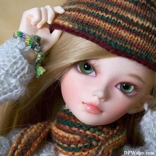 a doll wearing a knitted hat and scarf