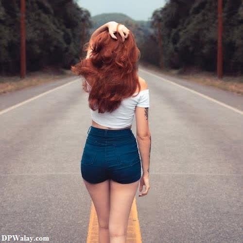a woman walking down a road with her hair in the air beautiful sad girl dp 