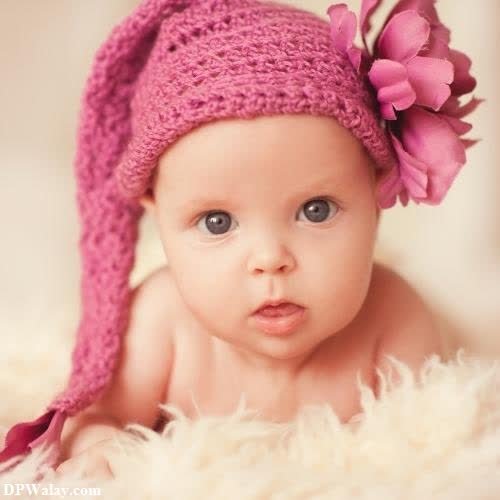 a baby girl wearing a pink hat with flowers beautiful whatsapp dp