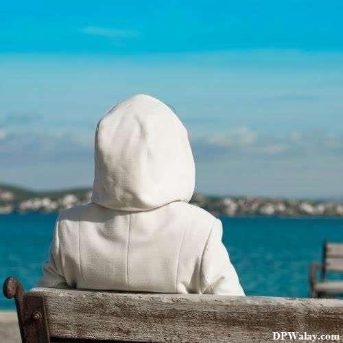 a child sitting on a bench looking out at the ocean best unique dp for whatsapp 