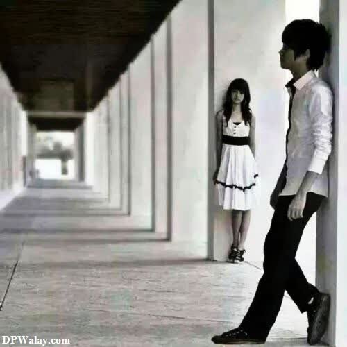 a man and woman walking down a long corridor breakup dp image