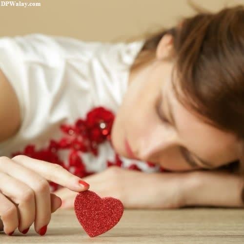a woman laying on the floor with a heart
