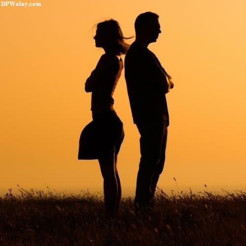 a couple standing in a field at sunset images by DPwalay