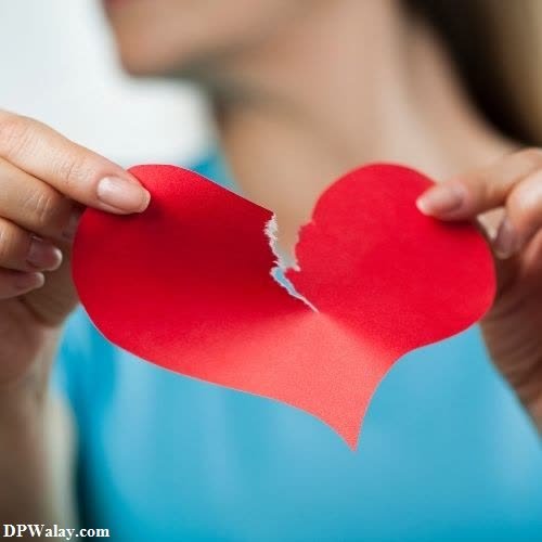 a woman holding a red heart in her hands-M5JS breakup images for whatsapp 