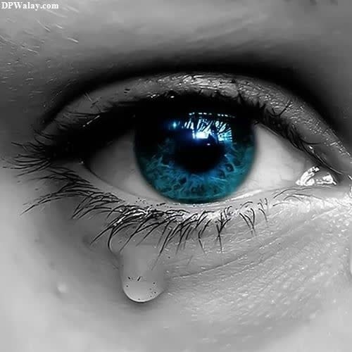 a close up of a blue eye broken heart dp for whatsapp