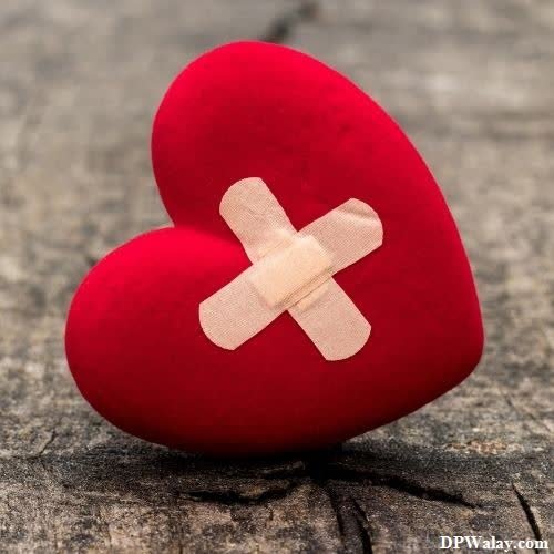 broken dp for whatsapp - a red heart with a bandage on it-zRAl