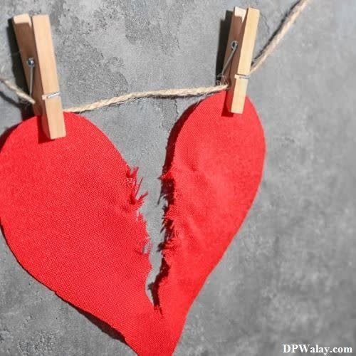 a heart hanging on a clothes line with clothes pins images by DPwalay