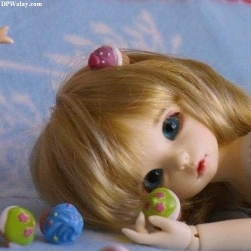 a doll laying on top of a bed