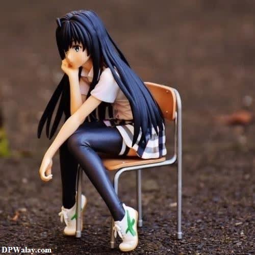 a doll sitting on a chair in the middle of a park 