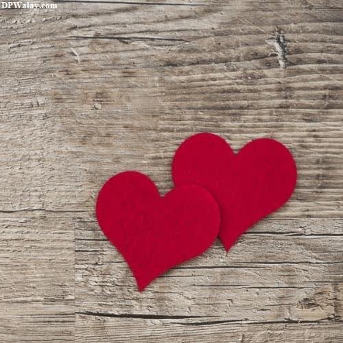 unique dp for whatsapp - two red hearts on a wooden background
