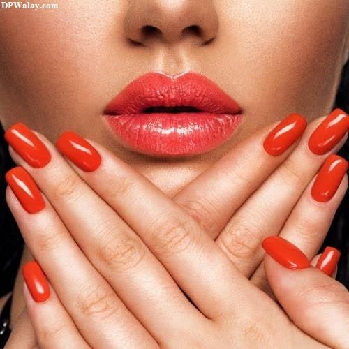 a woman with red nails and a red lipstick images by DPwalay