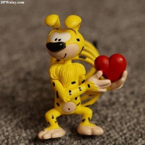 a toy figure holding a red heart 