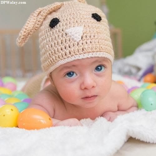 a baby wearing a crochet hat with a bunny on it cute do 