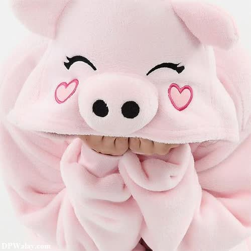 a stuffed pig with a pink bow around its neck 