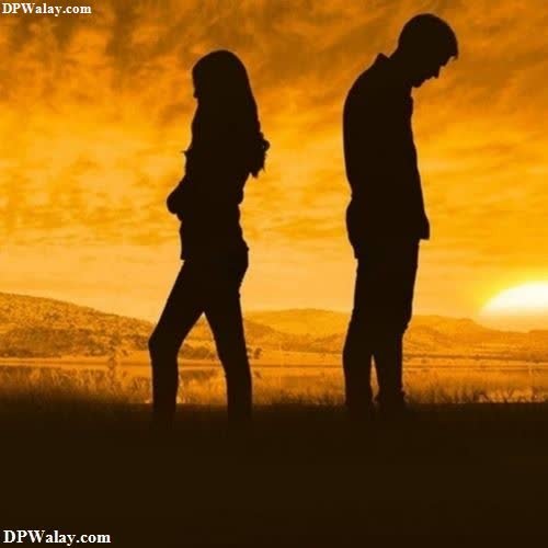 a couple walking in the sunset 