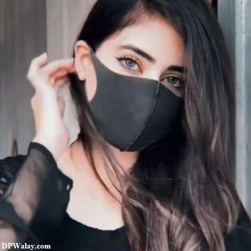 a woman wearing a black mask