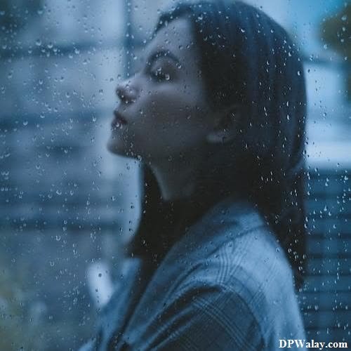 a woman looking out the window with rain on her face images by DPwalay