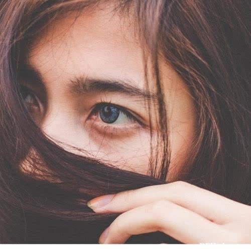 hidden face dp for girls - a woman with long brown hair and blue eyes