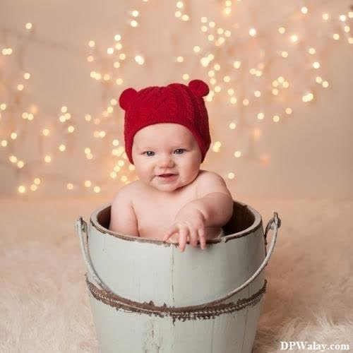 a baby in a bucket with a red hat dp images cute 