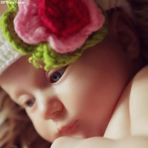 a baby girl wearing a flower headband