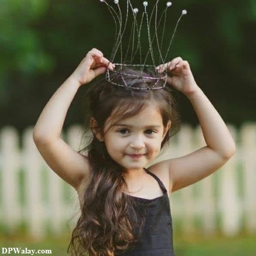 a little girl wearing a crown on her head dp images photography