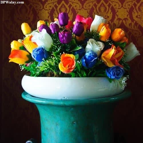 a vase filled with colorful flowers on a table dp images rose