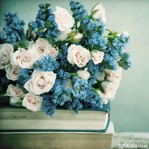 a bouquet of flowers on top of a book